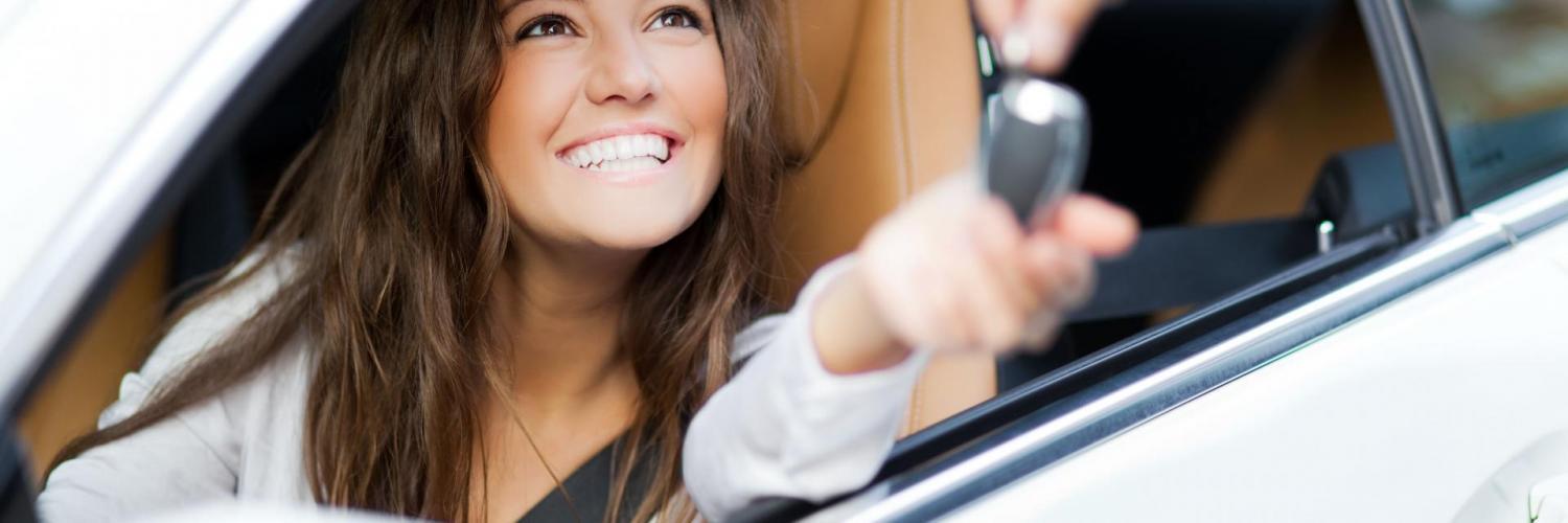 Woman smile in car give key